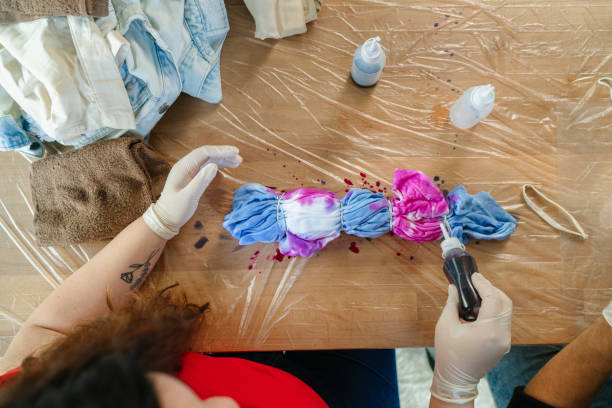 istock Young woman making tie dye indoors 1295491486