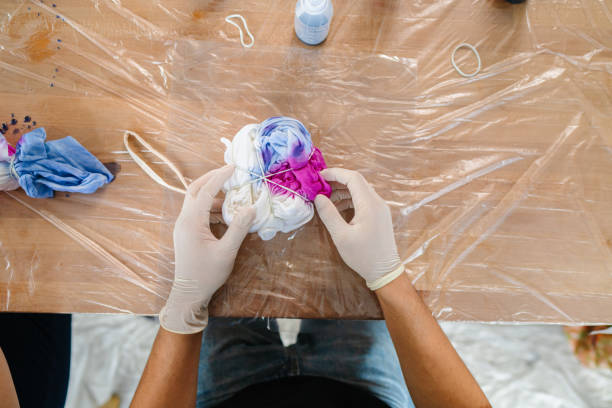 istock Young man making tie dye indoors 1295491577