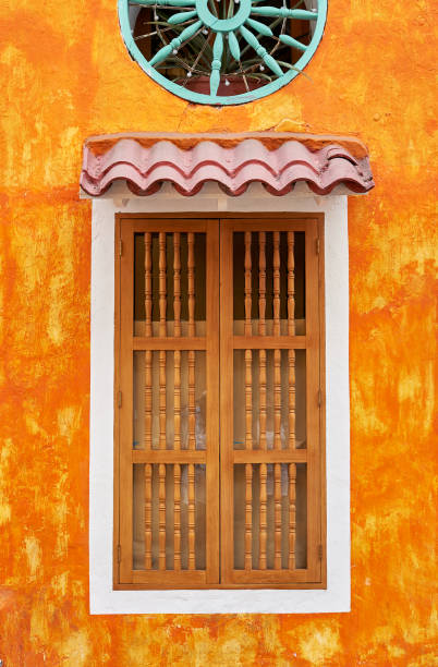 istock WINDOW WITH WOODEN SHUTTERS AND COLOURFUL FACADE 1295492197