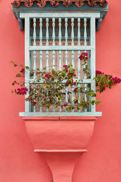 istock WINDOW WITH WOODEN SHUTTERS AND COLOURFUL FACADE 1295492739