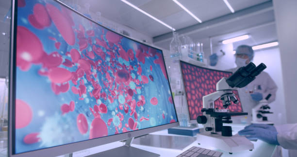 istock Futuristic laboratory equipment. Blood cells research on computer screens 1295492943