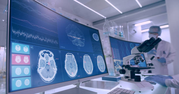istock Laboratory equipment, microscope and computers. Brainwave research on screens. Side view of scientist 1295492945