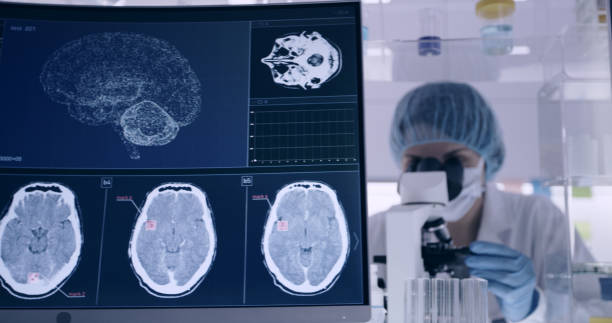 istock Laboratory equipment. Brainwave research on screens. Female scientist working with microscope in background 1295493010