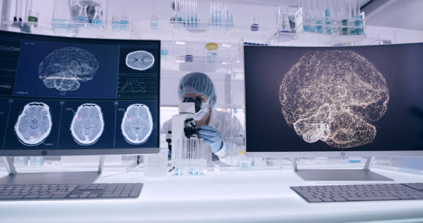 istock Laboratory equipment. Brainwave research on screens. Female scientist working with microscope in background 1295493014