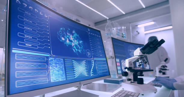 istock Laboratory equipment, microscope and computers. Brain models on screens. Rear view of scientists 1295493026