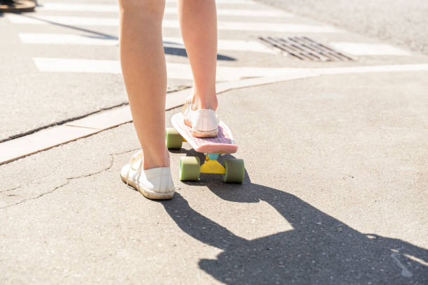 istock female slender legs on skateboard close up 1295494090