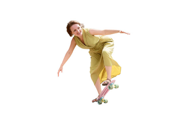 istock woman in a long dress performs tricks on a skateboard. isolate on white background 1295494247