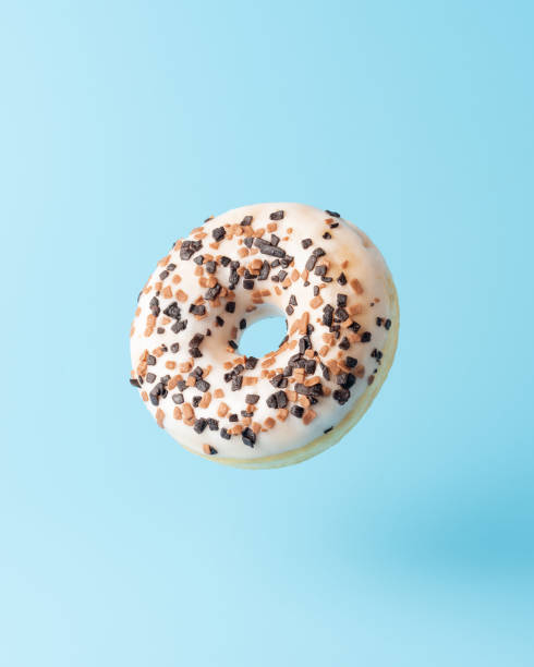 istock Fresh donut on blue background. Minimal food concept. 1295494420