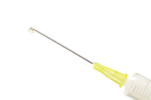 COVID-19 vaccine injection, syringe with corona serum, close up, free copy space, symbol picture
