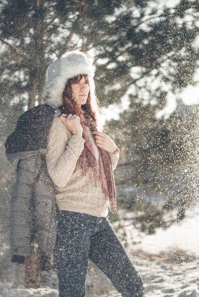 istock Woman stands in winter forest. 1295496871
