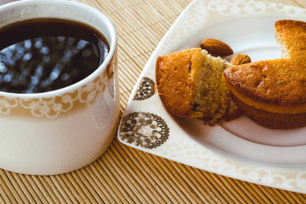 istock Cup of coffee and sliced ​​cake with almonds 1295497359