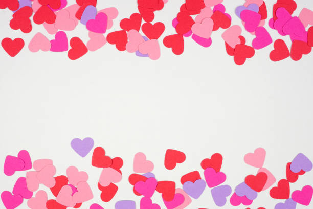 istock Valentines Day double border with paper heart confetti view over a white background 1295499816