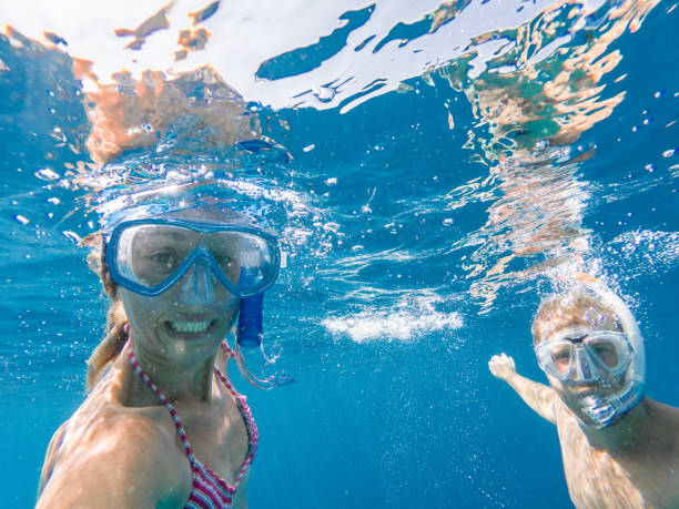 istock Young couple take selfie underwater with snorkelling mask 1295501847