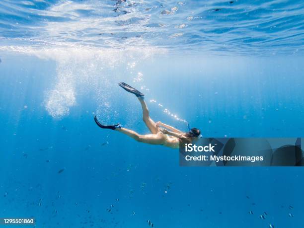 Woman Dives In Tropical Sea Underwater Shot Stock Photo - Download Image Now - Diving Into Water, Snorkeling, Underwater Diving
