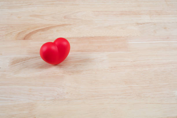 Red heart on wooden background with copy space