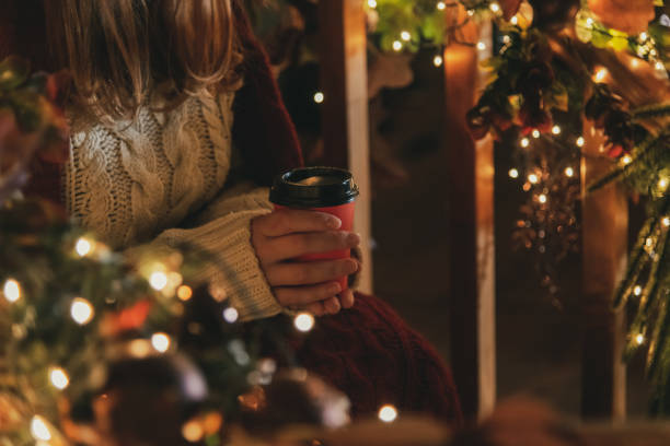 istock Woman holds red paper coffee cup 1295508744