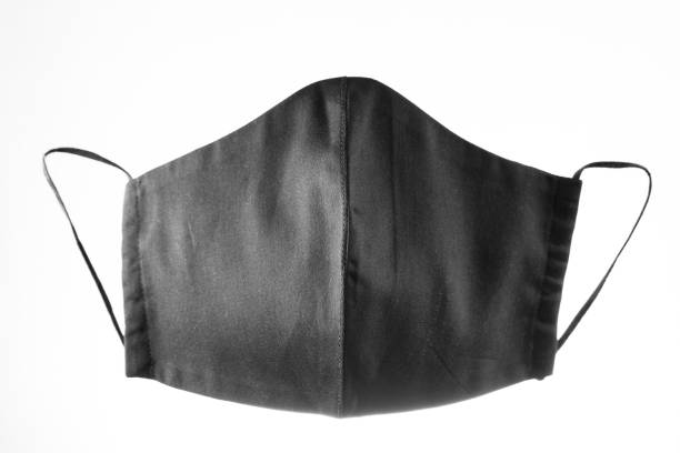 istock Face protective mask on white background. Black reusable face mask. Antivirus mask made from black cotton. Isolated 1295509544