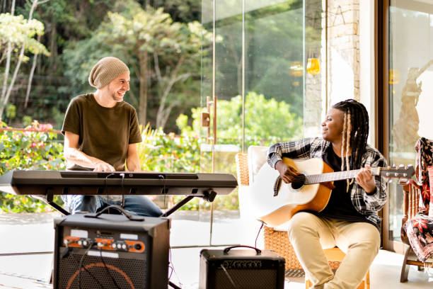 istock Two diverse young musician friends jamming together 1295509545
