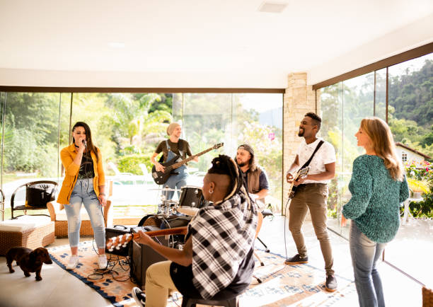 istock Smiling young musician friends jamming together in a home studio 1295509557
