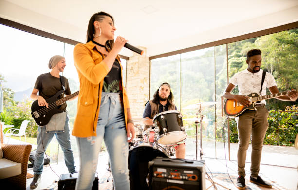 istock Young musicians having a band rehearsal session in a home studio 1295509600