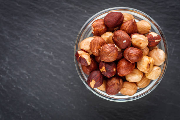 istock fresh natural hazelnuts on a dark stone background 1295512185