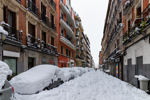 January, 2021, Madrid, Spain. A view to a street after the Filomena snow storm. Some random walkers.