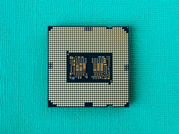 istock Pc micro CPU with gold plated contacts on a textured turquoise background. Modern central processing unit close-up. Desktop computer hardware components for assembly, upgrade and repair. Macro. 1295519587