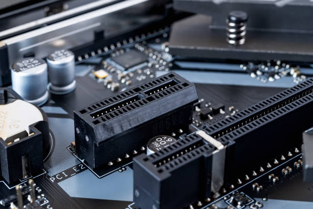 istock PCI-E expansion slot on a modern black motherboard. Computer mainboard circuit components. Desktop hardware close-up. PC components for assembly, upgrade and repair. Macro. 1295519599