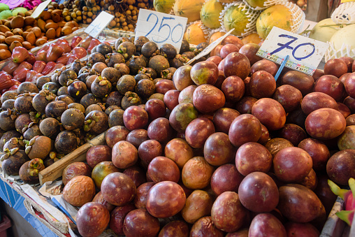 Pile of passionfruit, mangosteen, bell apples and other fruit for sale at a market stall, Thailand