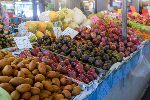 Pile of passionfruit, mangosteen, bell apples and other fruit for sale at a market stall, Thailand