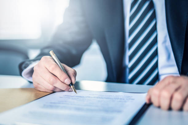 istock Business man signing contract, making a deal. 1295525217