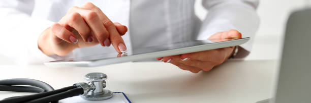 istock Female doctor hold digital tablet pc and point in touch screen 1295525334