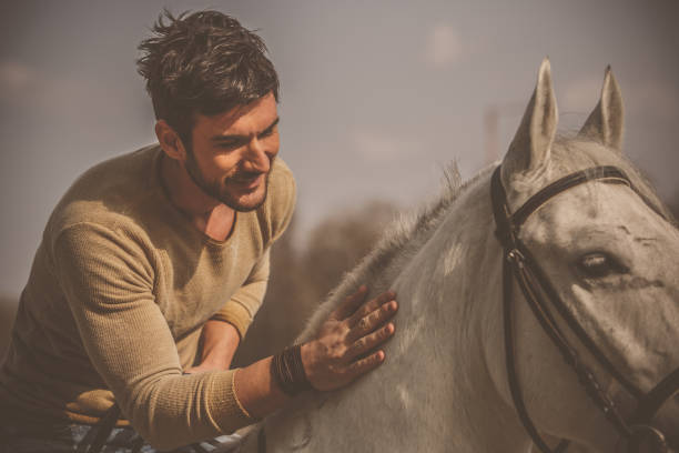 istock Man having a bonding moment with his horse while riding him 1295527393