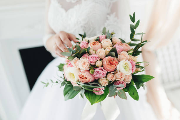 istock Bride in white dress is holding wedding bouquet 1295527597