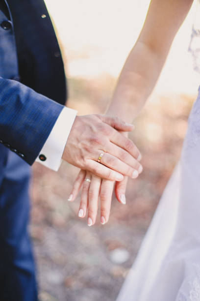 istock Groom holds bride hand in white dress 1295527598