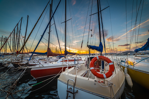 Boats in Alghero harbor at sunset. Sardinia, Italy