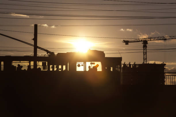 Trolleybus moves across the bridge in backlight