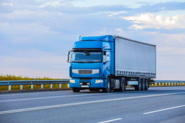 istock truck goes on highway on sunset 1295528513