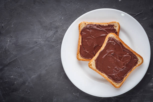 istock toasts with chocolate butter on a dark stone background 1295530614