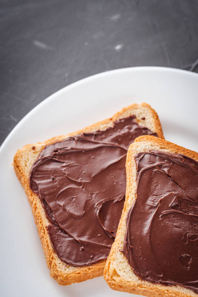 istock toasts with chocolate butter on a dark stone background 1295530618