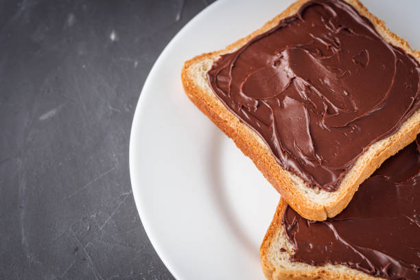 istock toasts with chocolate butter on a dark stone background 1295530636