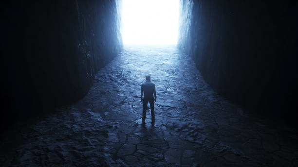 istock a lonely man stands in front of a light portal. 3d rendering. 1295532190