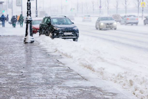 istock De-icing chemicals on winter road, Reagent - technical salt will make the road safe 1295533935