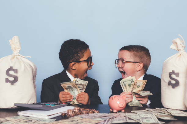 Young Business Boys Making Money A business team of young boys have figured out the perfect business model and are swimming in success. Making loads of money for your business requires hard work, teamwork, and a little luck. piggy bank photos stock pictures, royalty-free photos & images