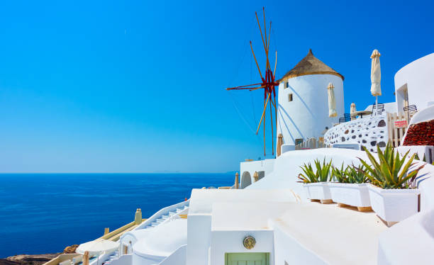 istock Greek landscape with old windmill in Santorini 1295537475