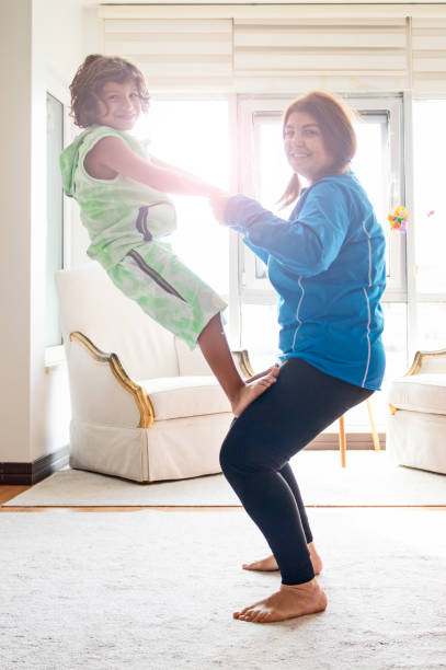 istock Beautiful mother holding her little boy and practicing yoga 1295538435