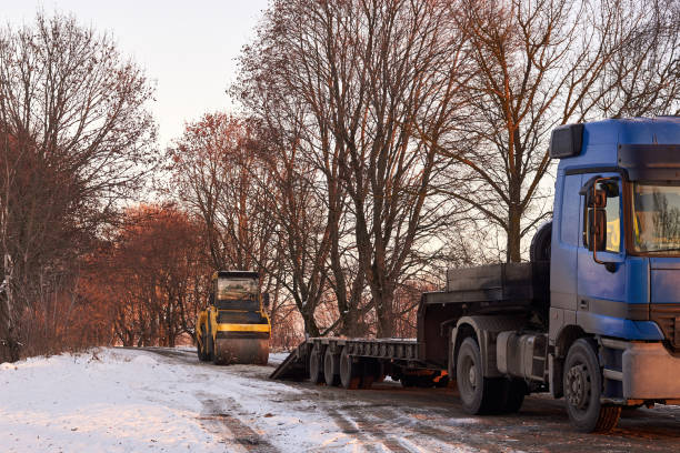 istock Asphalt roller during road repairs in winter. 1295539275
