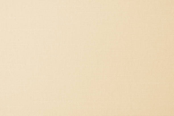 istock Cotton silk fabric wall paper texture pattern background in light pastel white yellow cream beige sepia tan brown color earth tone 1295540014