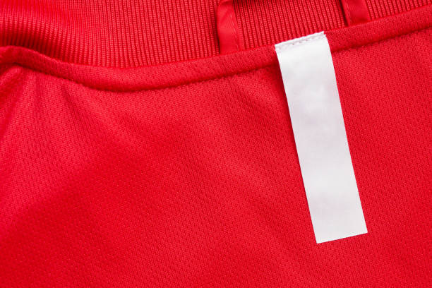 istock White blank clothes label on red jersey texture background 1295540250
