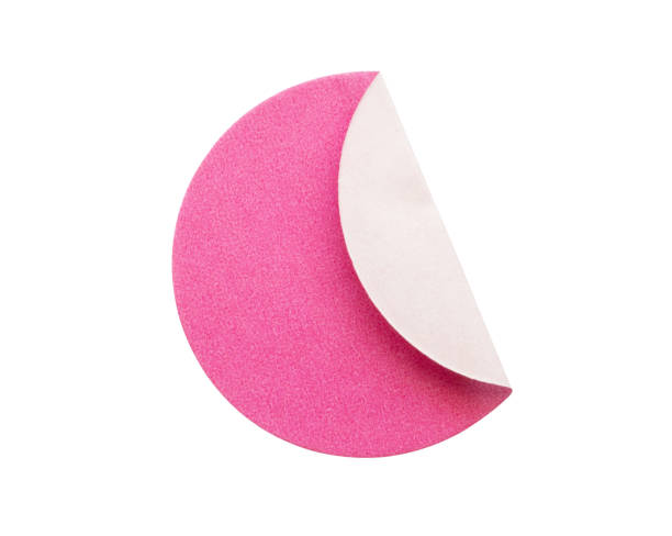istock Blank pink round adhesive paper sticker label isolated on white background 1295540392